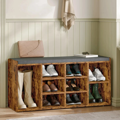 [White] Pair of shoe storage benches lining hallway wall with cushions, boots and shoes filling cubbies